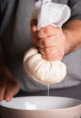 Horchata making of, man hands squeezing horchata paste.