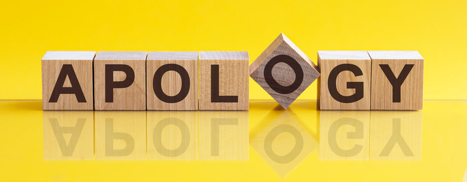APOLOGY - word from wooden blocks with letters, sorry concept, yellow background.
