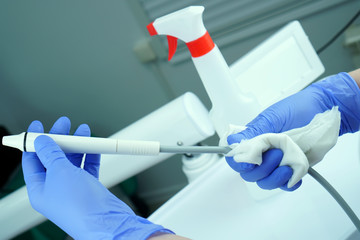 A medical professional cleans and disinfects a medical instrument from germs. Stylishness and...