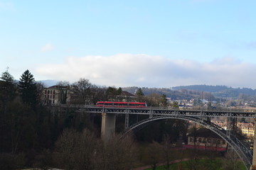 Bern landscape: bridge over the river and red train