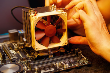 Repairman repairs the computer, Removing the computer motherboard.
