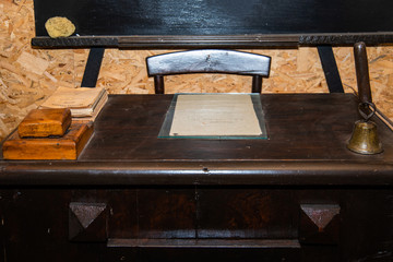 Vintage school classroom with wooden bench and desk and old blackboard. Old Serbian school classroom