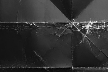 Crumpled black paper with wrinkles and rubbed corners. Old wrapping dusty cardboard