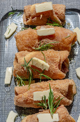 Preparation of chicken rolls stuffed with provola on the surface.