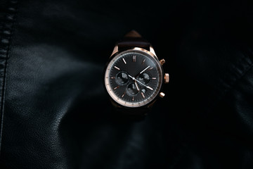 Gold LEATHER WATCH, VINTAGE STYLE WRIST WATCH, MEN'S LEATHER WATCH on leather background blur.