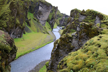 Sudhurland / Iceland - August 15, 2017: River flow through the great canyon of Fjadrargljufur.