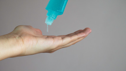 Bottle with antibacterial antiseptic gel in hand.