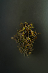 Cannabis bud isolated on black background. Vertical orientation. Copy space