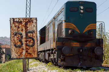 Railroad Sign 35 With Train Passing By