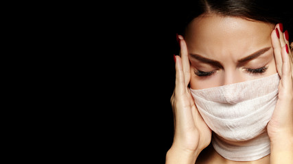 Beautiful woman with bandage mask on face. Fashion eye make-up. Beauty surgery or protection...