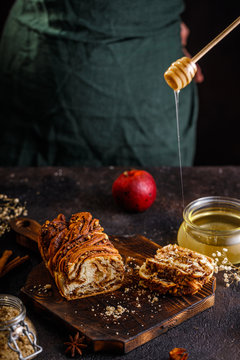 Swirl brioche or traditional Polish babka cake with walnut, apple and honey