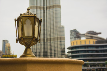 Fototapeta na wymiar Golden antique Arabian style lantern in Dubai. Behind the Burj Khalifa building.