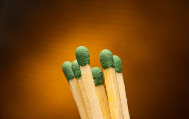 Macro matchsticks against an orange background .