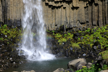 Fototapeta premium Skaftafell / Iceland - August 18, 2017: The black waterfall of Svartifoss in Skaftafell National Park, Iceland, Europe