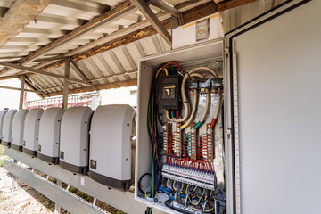 Electrical panel at a assembly line factory. Controls and switches. Color wires in a box of...
