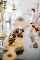 Salmon appetizers on the wedding table. the table is set for the party. full glasses of cognac