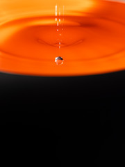Orange water drop with black background