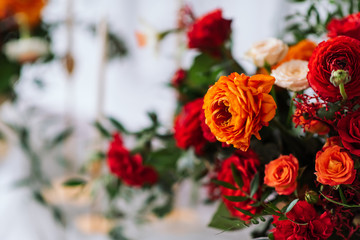 red and orange flowers in the wedding decor