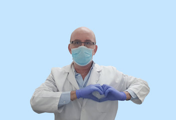 Doctor with surgical mask and gloves making heart symbol on blue background