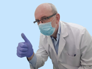 Ok thumb of a male nurse with surgical mask on blue background