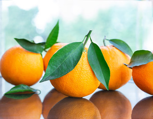 fresh ripe oranges with leaves