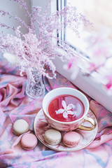 Obraz na płótnie Canvas cup of tea with flower petals