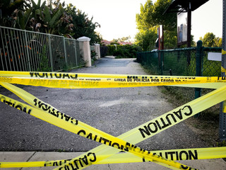 Yellow caution tape banning entrance to the city park trail