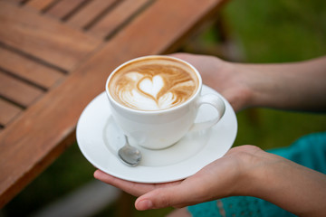woman hands with coffee cup