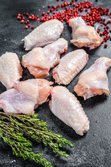 Raw chicken wings, organic poultry meat. Black background. Top view