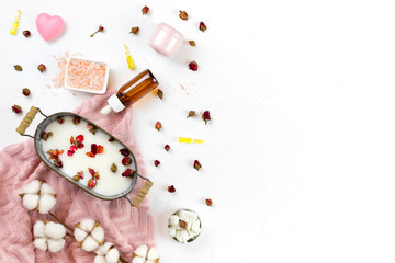 self-care kit for body, hair, face. soap nuts, rose petals, coconut oil, soap bath , salt, pink towel. DIY eco cosmetics. concept zero waste, no plastic, sustainable. copy space. flat lay