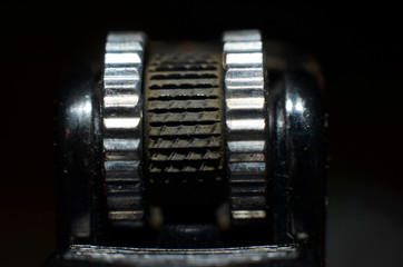 black serrations with silver round list as a tool to light a match
