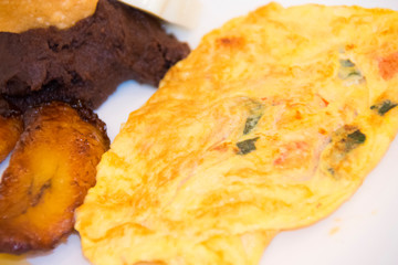 White plate with breakfast served, typical Guatemalan food, nutritious and delicious in a city hotel.