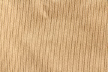 Beige synthetic fabric for wallpaper design. Weave cotton background texture.