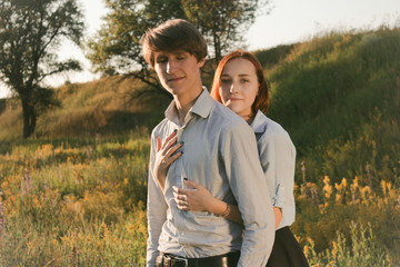 Young couple in the field. Green grass