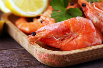 Raw fresh Prawns Langostino Austral. shrimp seafood with lemon and spices on background