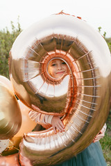 little princess in a luxurious dress and with balloons