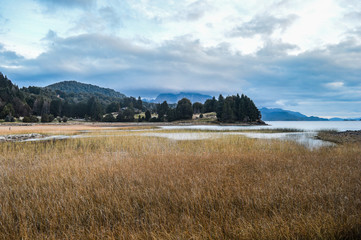 Ice lake, as part of the Annapurna Circuit Trek detour, Himalayas, Nepal. Annapurna chain in the back, covered with snow. Clear weather, dry grass, snowy peaks. 