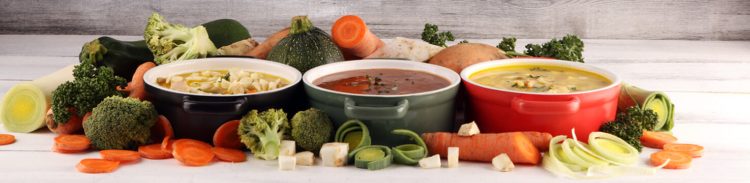 Set of soups from worldwide cuisines, healthy food. Broth with noodles, beef soup and broth with marrow dumplings. All soups with healthy vegetables on table