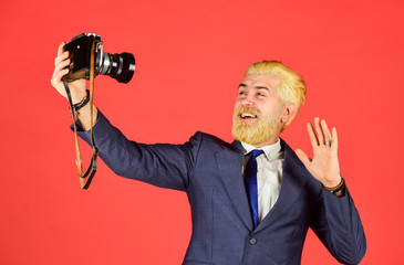 Following his personal style. mature man dyed beard and hair. professional photographer make selfie photo. capture result of barbershop salon. vintage camera. happy businessman hold retro camera