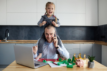 Father Working from home on laptop during quarantine. Little child girl make noise and distracts...
