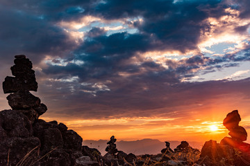 sunset with clouds and rocks in a desert