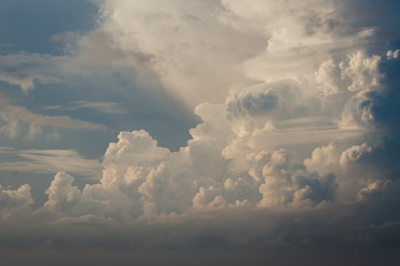 Large white cumulus clouds against a blue sky.