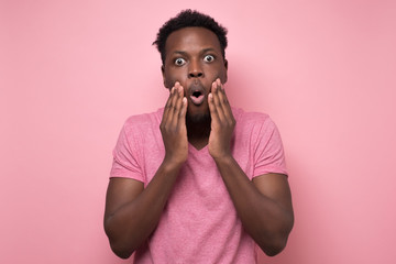 african american man looking at the camera in surprise, stunned with a story