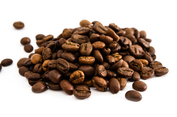 Pile of roasted coffee beans isolated on white background.