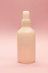 plastic white bottle on pink background