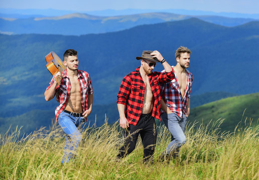 free walk. group of people spend free time together. hiking adventure. cowboy men. western camping. campfire songs. happy men friends with guitar. friendship. men with guitar in checkered shirt