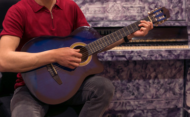 man playing guitar in studio