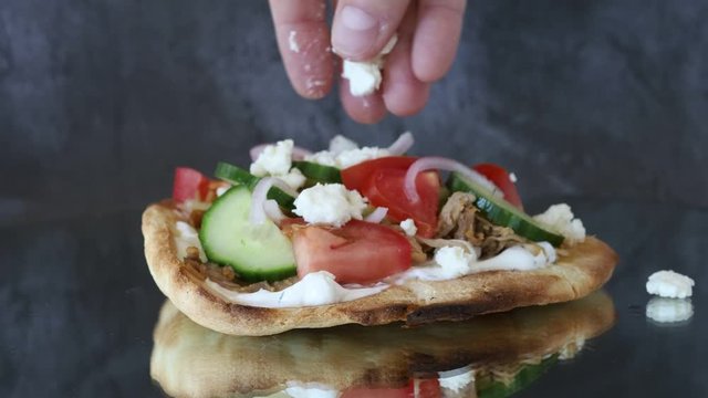Adding Feta Cheese to a Greek Gyro Flabread