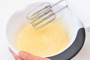 Mixing biscuit dough with an electric mixer. close up process. Cake batter making.