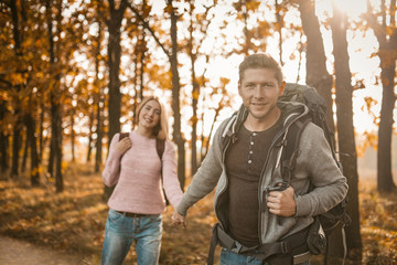 Lovely Couple Of Travelers Walk Along A Forest Trail